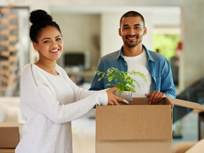 Couple packing boxes to move houses